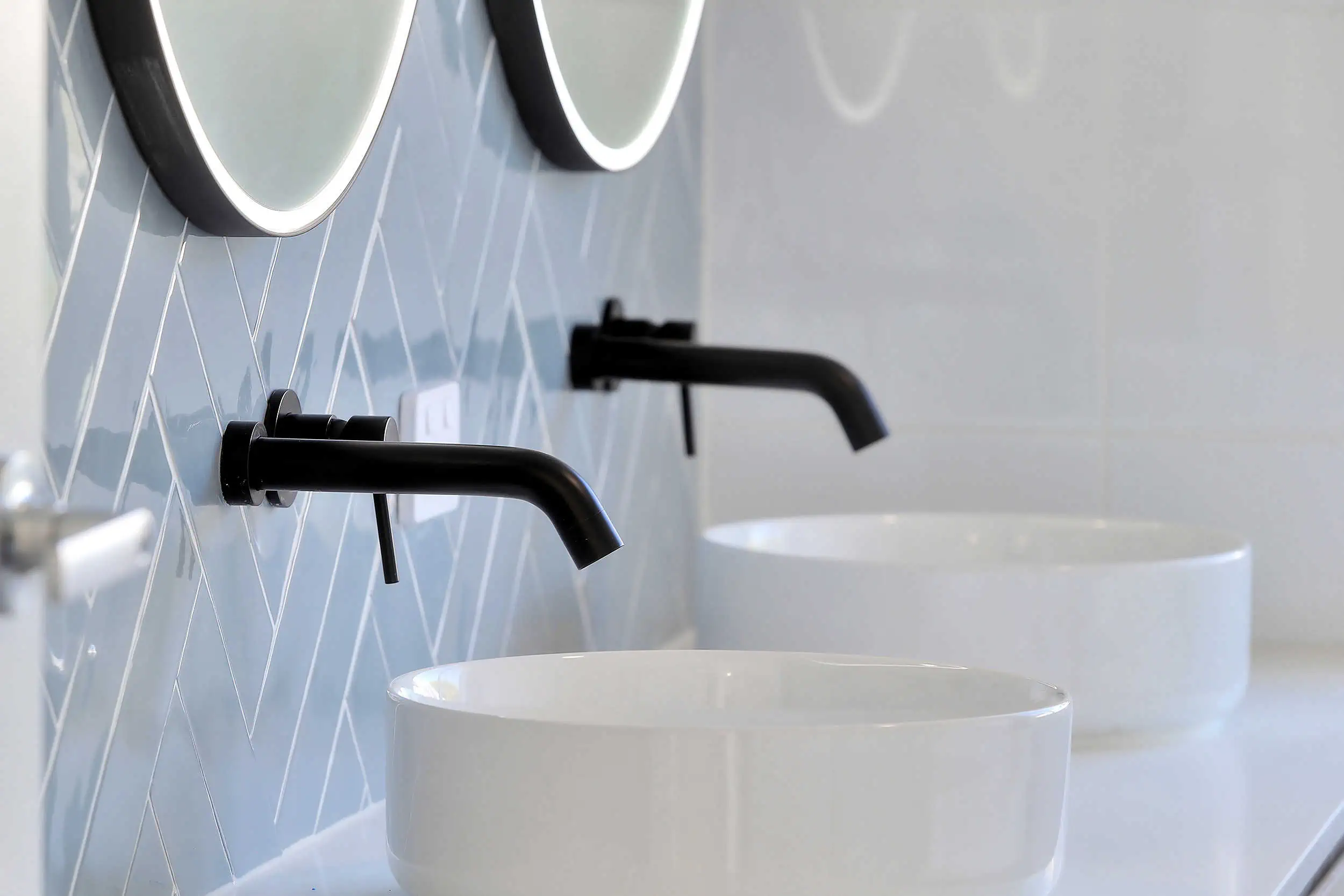 Two sinks on a vanity unit in a fresh new bathroom