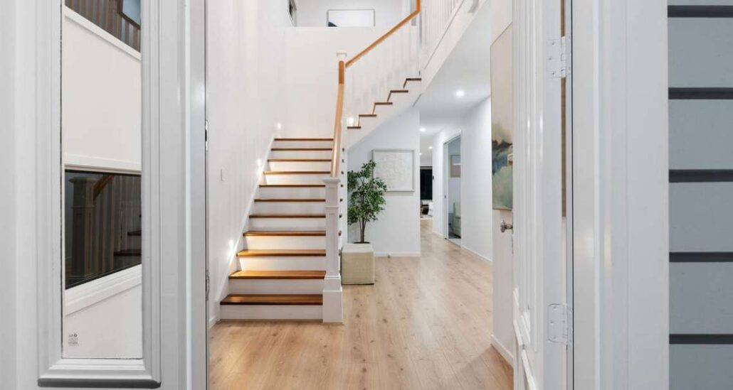 Photograph of a modern hallway and staircase in a narrow lot home